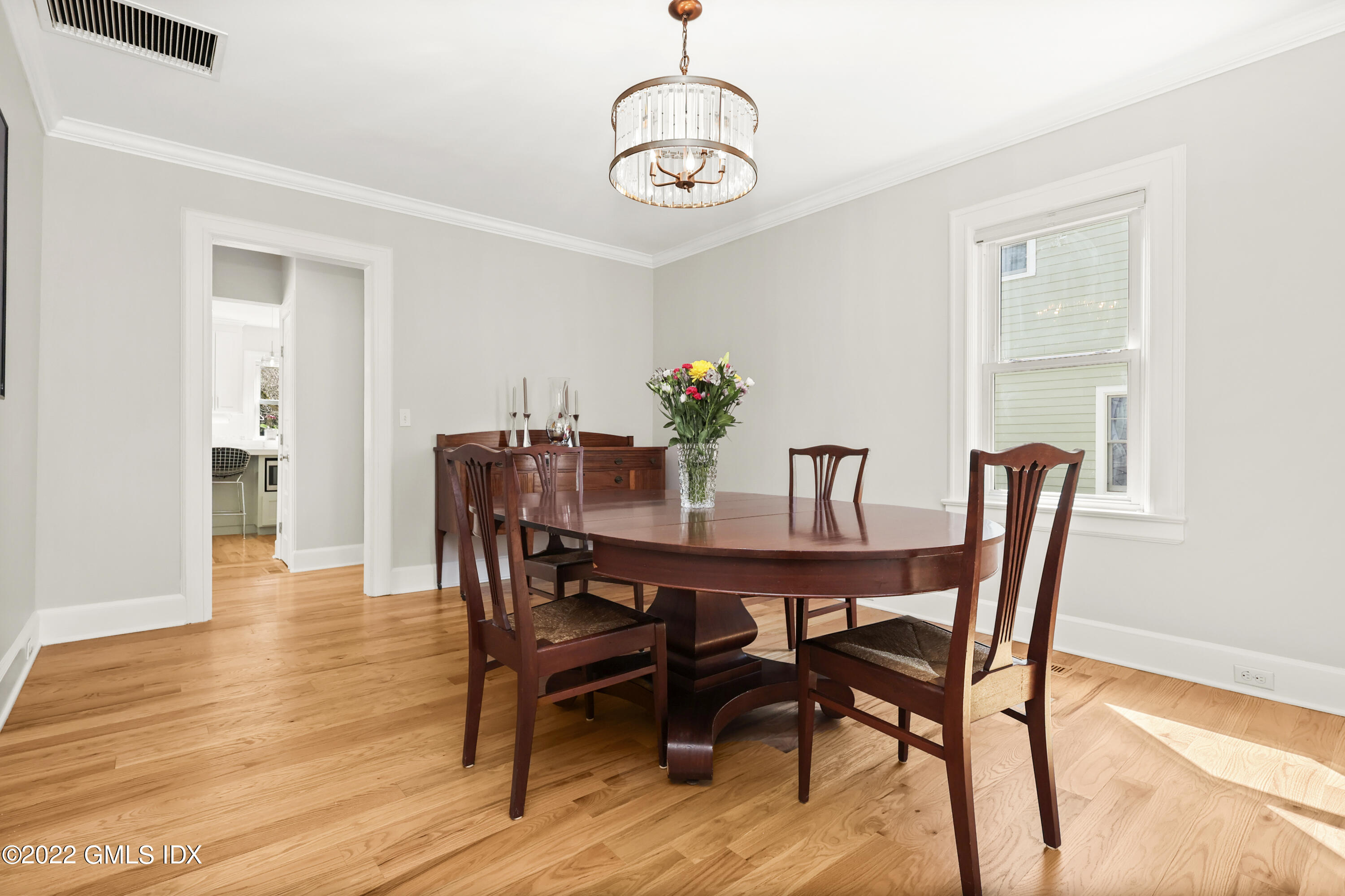 10 Butler Street Cos Cob, CT 06807 - Photo 13 of 43 a view of a dining room with furniture wooden floor and a chandelier