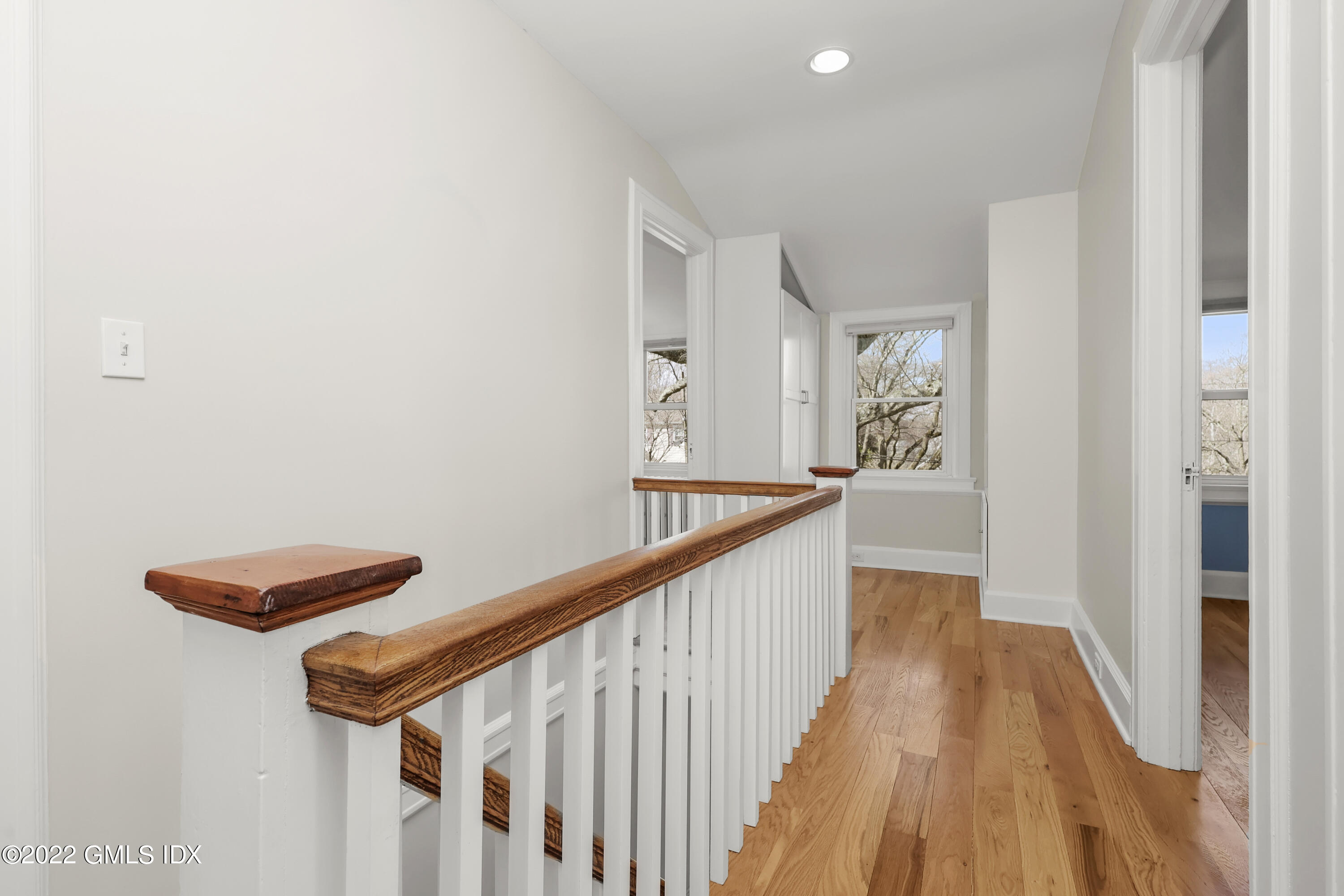 10 Butler Street Cos Cob, CT 06807 - Photo 14 of 43 a view of a hallway with wooden floor and staircase