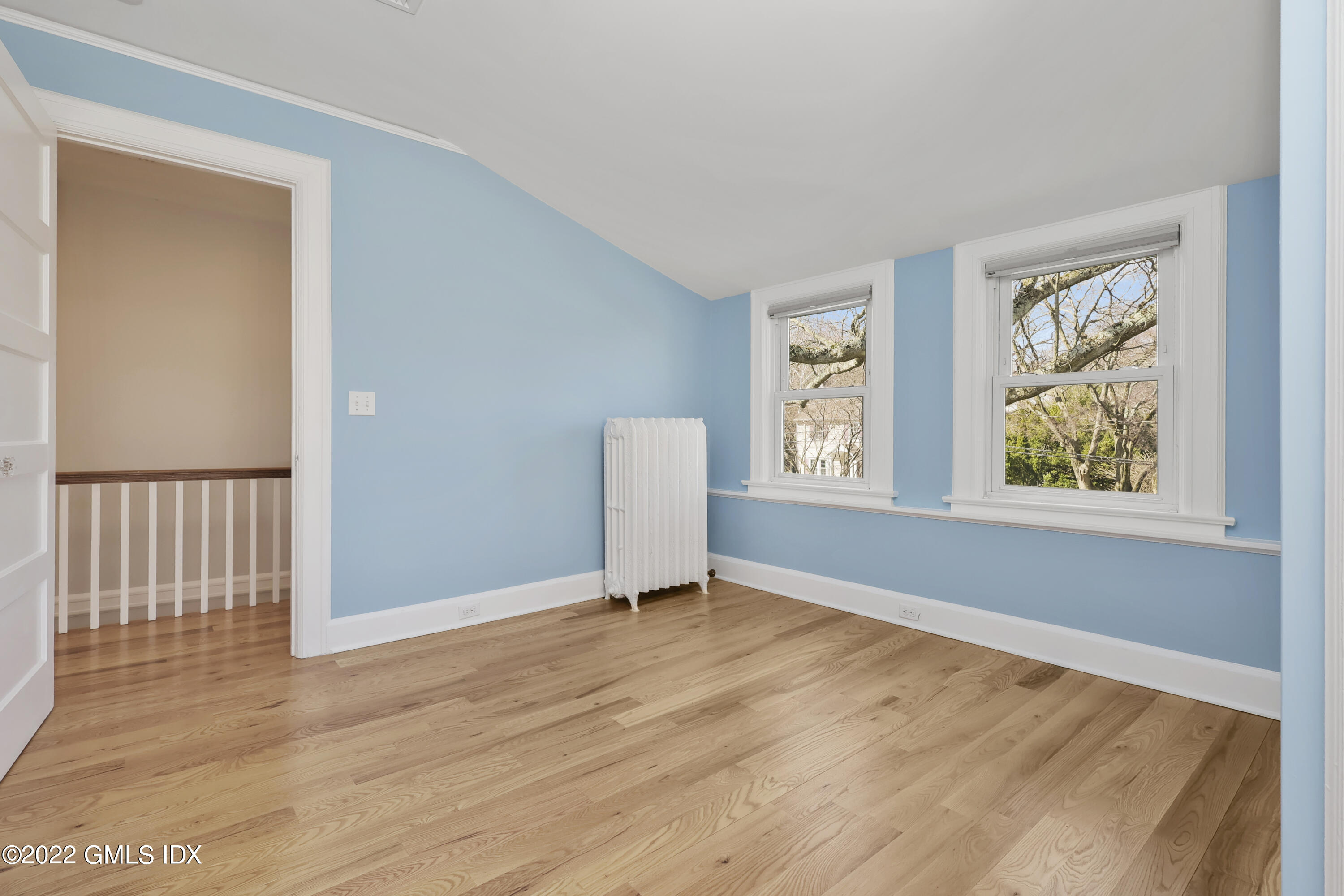 10 Butler Street Cos Cob, CT 06807 - Photo 23 of 43 a view of an empty room with wooden floor and a window