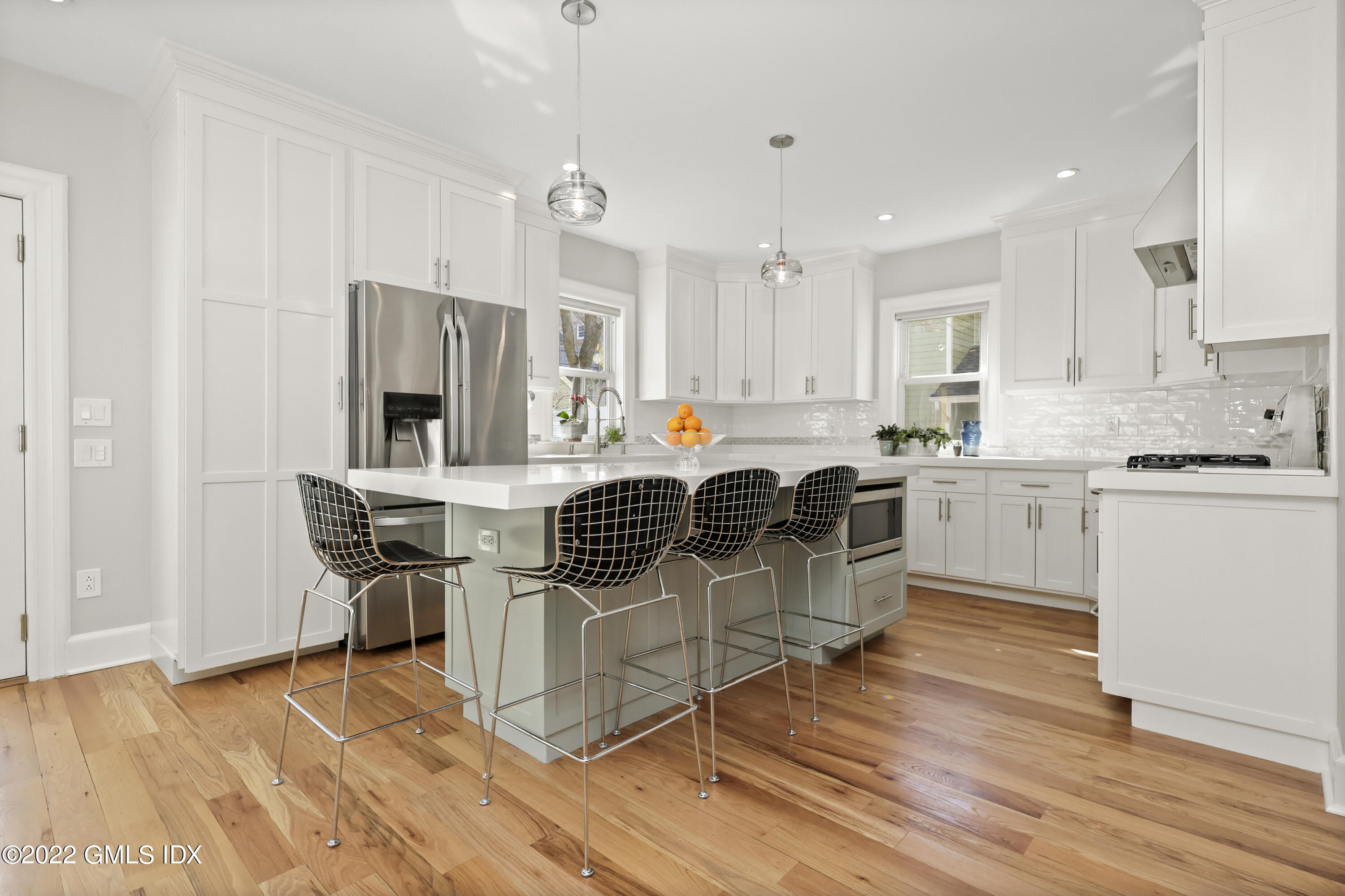 10 Butler Street Cos Cob, CT 06807 - Photo 3 of 43 a kitchen with kitchen island granite countertop a sink cabinets and wooden floor