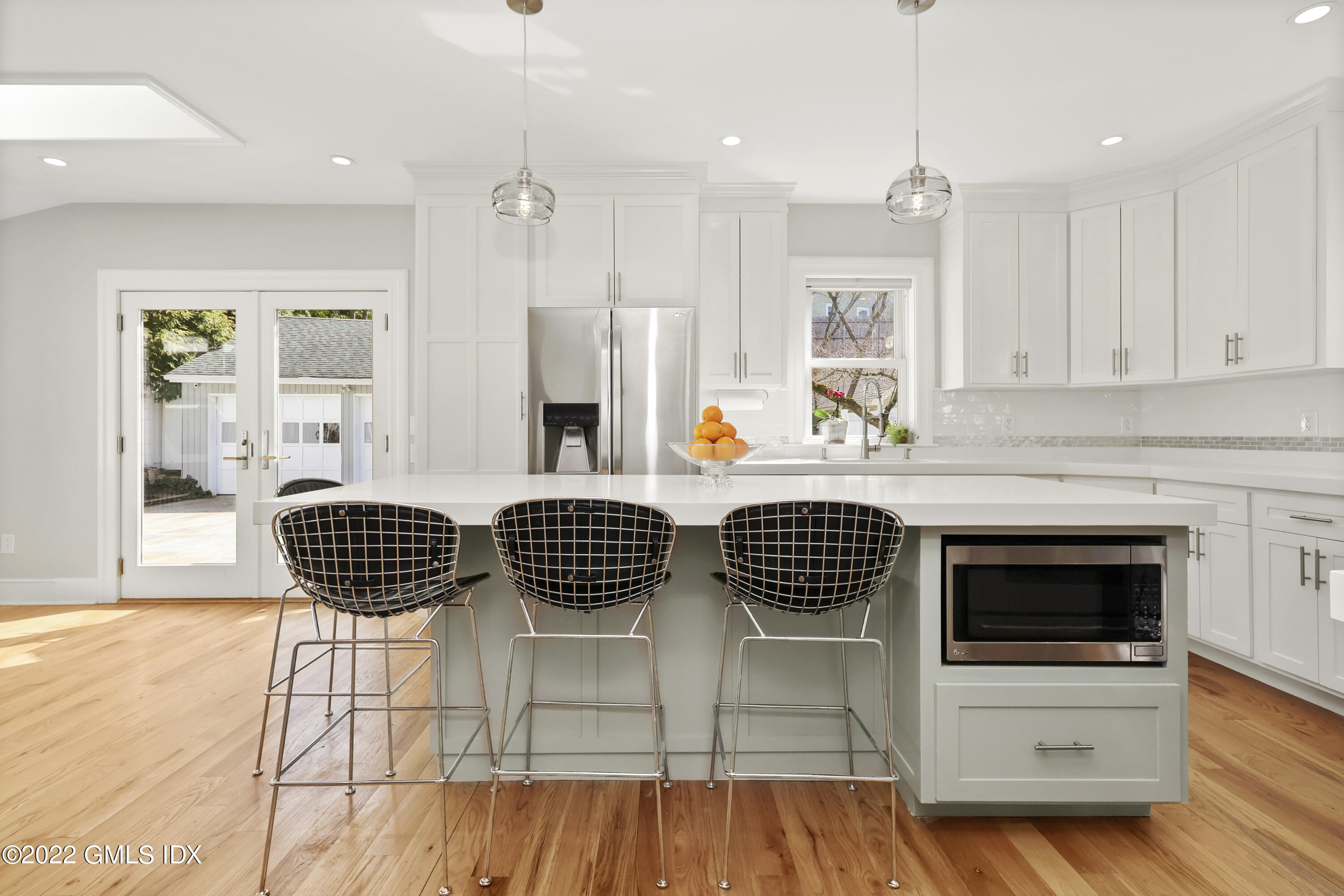 10 Butler Street Cos Cob, CT 06807 - Photo 4 of 43 a outdoor kitchen with a sink a stove a dining table and chairs