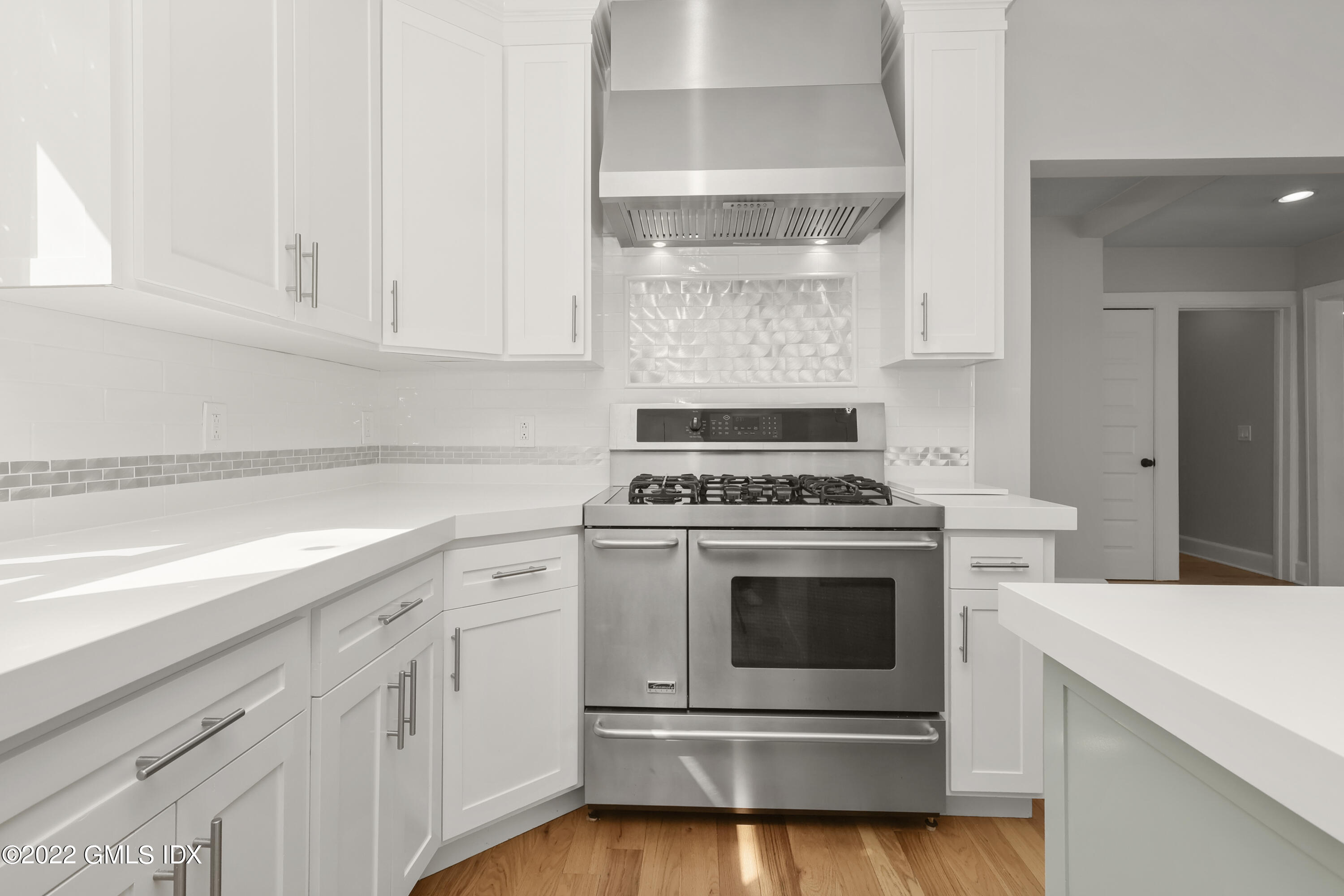 10 Butler Street Cos Cob, CT 06807 - Photo 7 of 43 a kitchen with white cabinets and white appliances