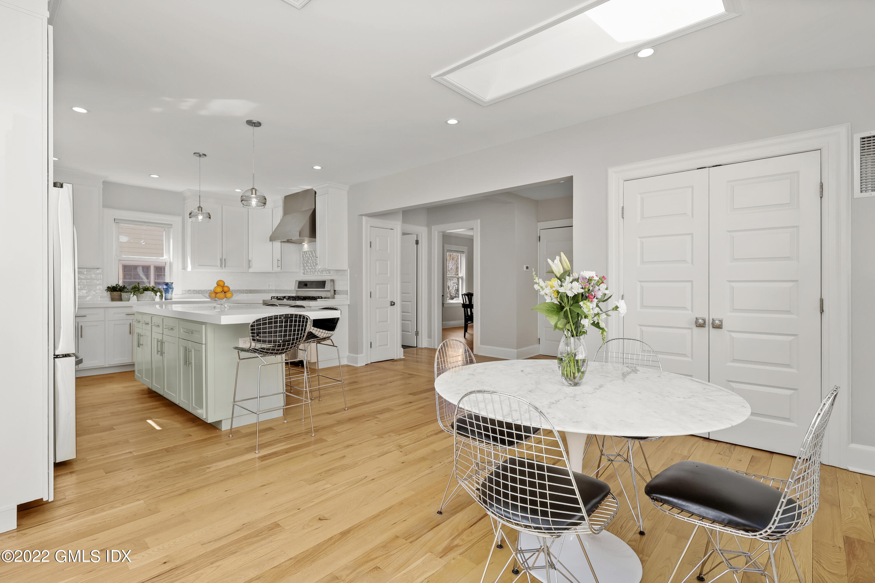 10 Butler Street Cos Cob, CT 06807 - Photo 8 of 43 a kitchen with stainless steel appliances kitchen island granite countertop a refrigerator a stove a sink dishwasher and white cabinets with wooden floor