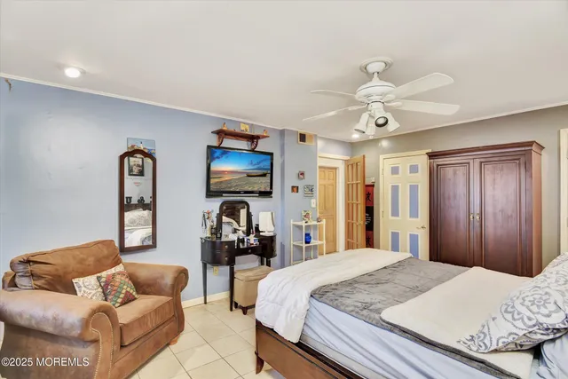 a bedroom with a bed and ceiling fan