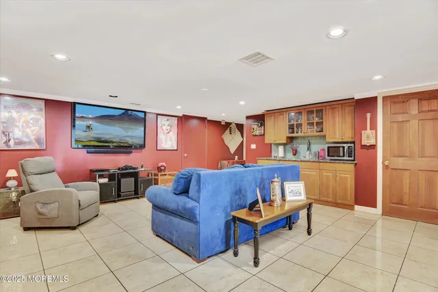 a living room with furniture and kitchen view
