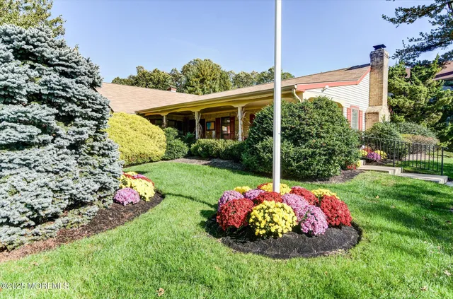 a view of a house with a backyard