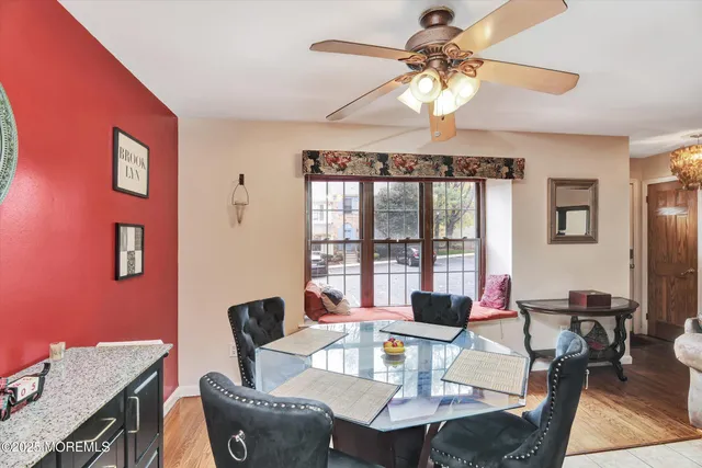 a dining room with furniture a chandelier and wooden floor
