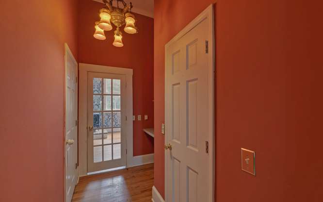 330 River Road Westminster, SC 29693 - Photo 21 of 45 A well-lit hallway with gleaming wood floors and a glass-paneled door invites you further into the home.