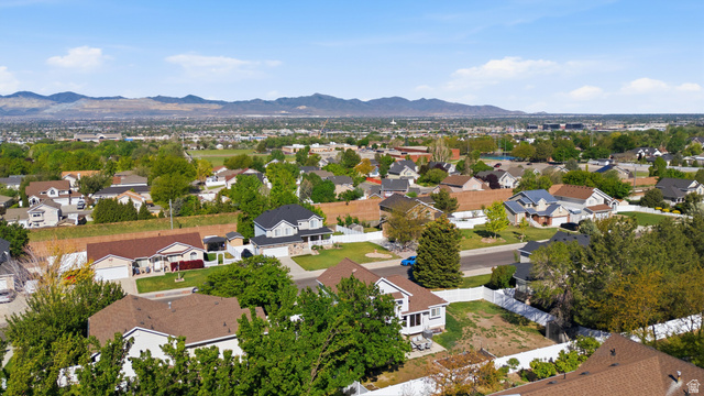 11189 Ohenry Road East Sandy, UT 84070 - Photo 38 of 44 Aerial perspective showcasing a residential area with a prominent mountain range in the distance