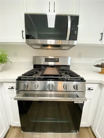 a stove top oven sitting inside of a kitchen