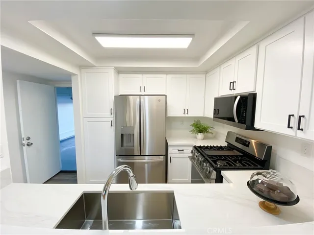 a kitchen with stainless steel appliances a refrigerator stove and microwave
