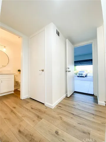 a view of a kitchen with a sink and a refrigerator
