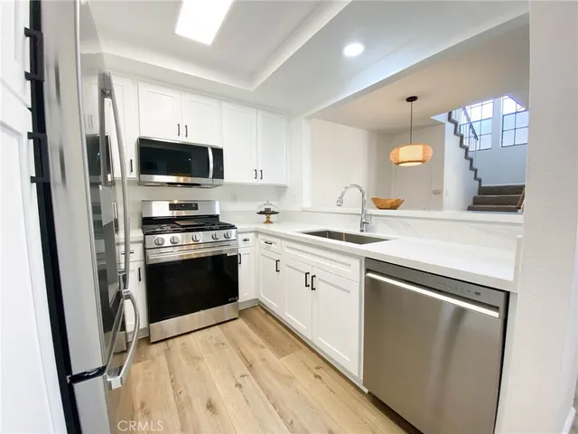 a stove top oven sitting inside of a kitchen