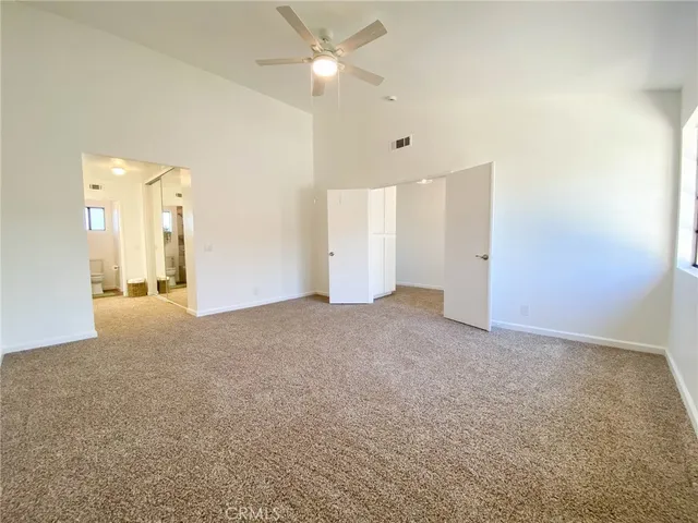 a view of a livingroom with wooden cabinets