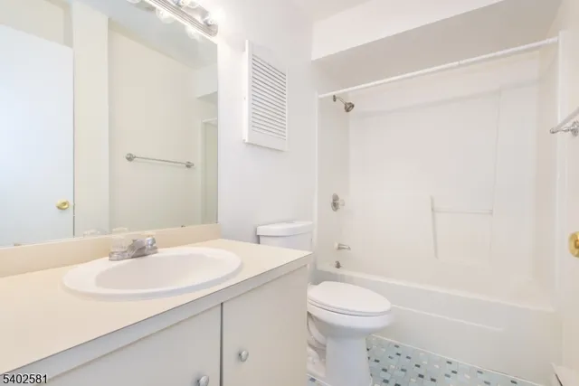 a bathroom with a sink toilet vanity and shower
