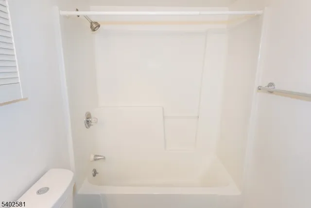 a bathroom with a bathtub and a toilet