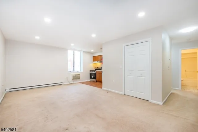 an empty room with windows and closet