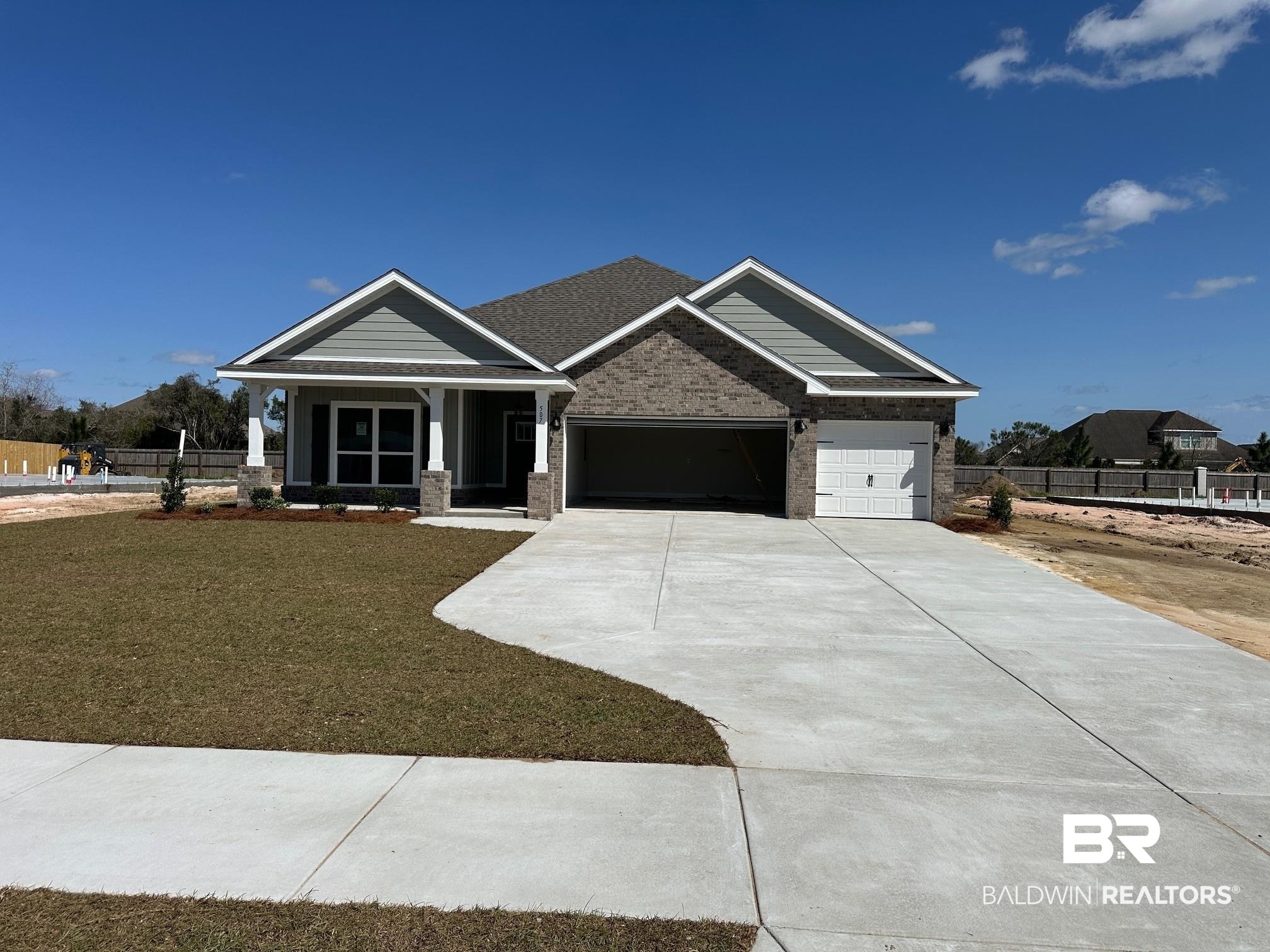 507 Preston Way Gulf Shores, AL 36542 - Photo 2 of 37 Craftsman-style home with an attached garage, covered porch, concrete driveway, and brick siding