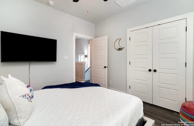 a bedroom with a bed and a flat screen tv