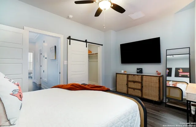 a bedroom with a bed and a flat screen tv