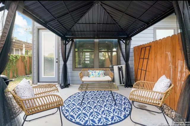 a backyard of a house with table and chairs
