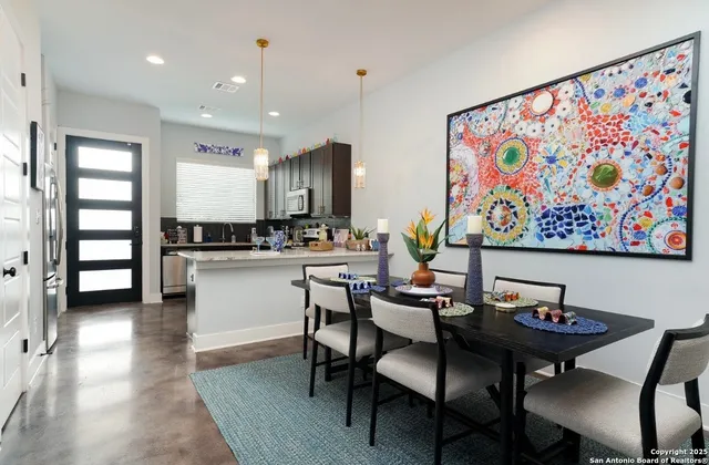 a view of a dining room with furniture and wooden floor