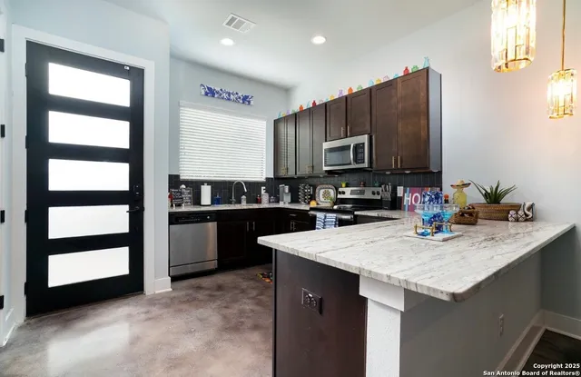 a kitchen with a sink and cabinets