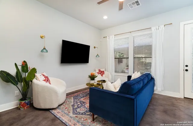 a living room with furniture and a flat screen tv
