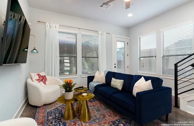 a living room with furniture and a large window
