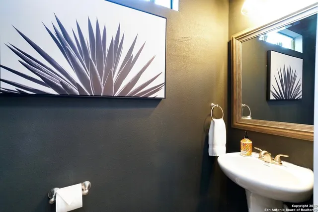 a bathroom with a sink a toilet and mirror