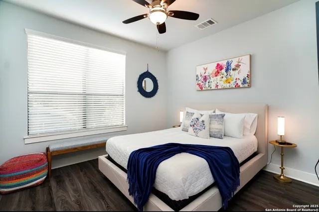 a bedroom with a bed and a chandelier