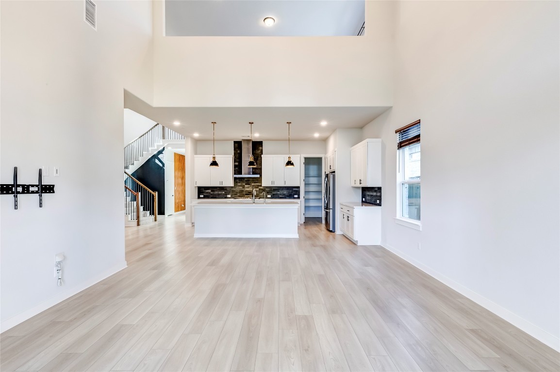 129 Cotton Tree Terrace Dripping Springs, TX 78620 - Photo 10 of 40 a view of kitchen view wooden floor and window