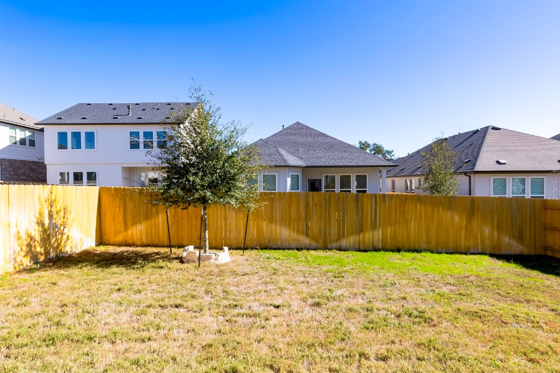 129 Cotton Tree Terrace Dripping Springs, TX 78620 - Photo 33 of 40 a front view of a house with a yard