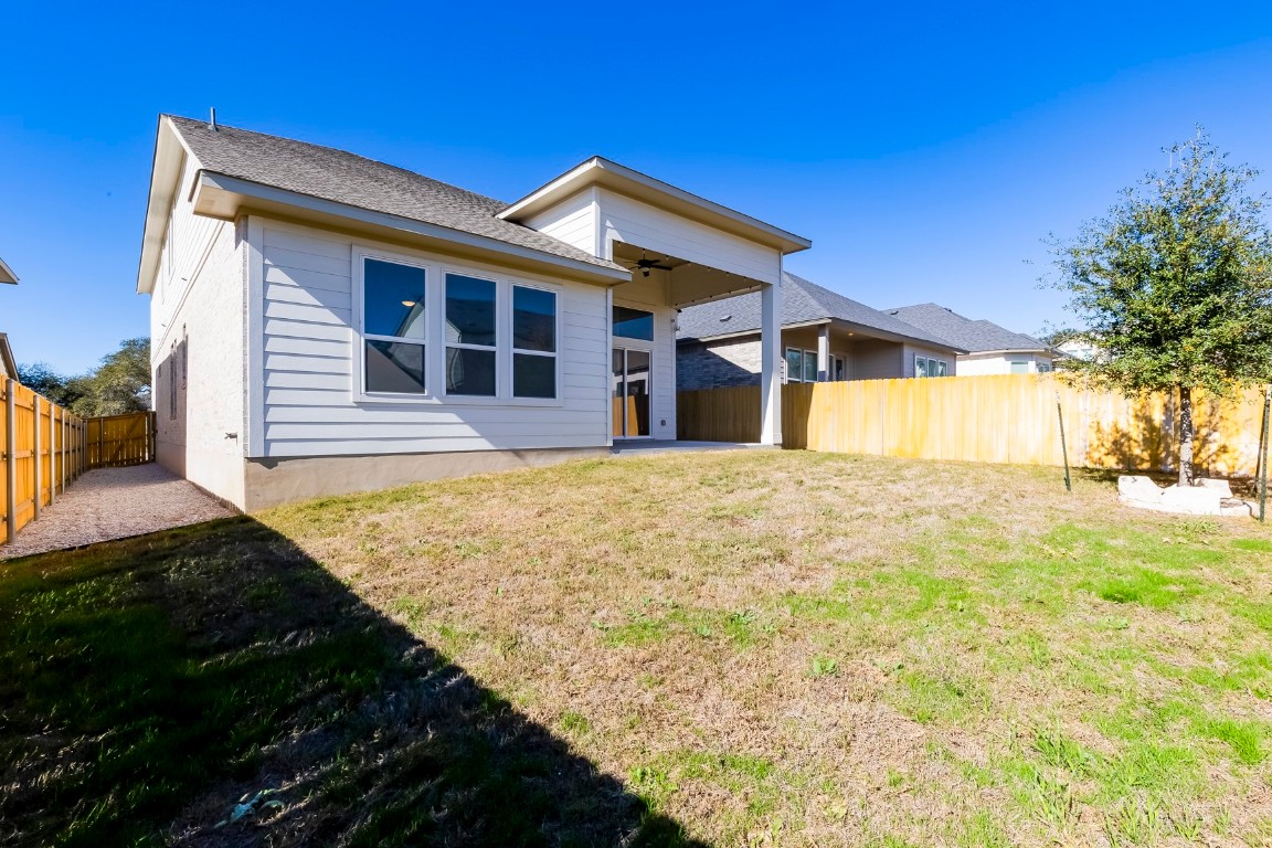 129 Cotton Tree Terrace Dripping Springs, TX 78620 - Photo 35 of 40 a front view of a house with a yard