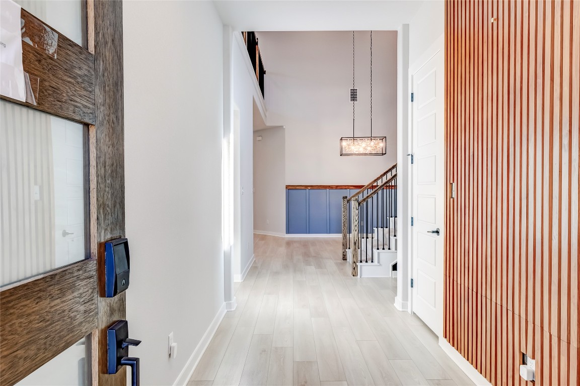 129 Cotton Tree Terrace Dripping Springs, TX 78620 - Photo 6 of 40 a view of a hallway with wooden floor and staircase
