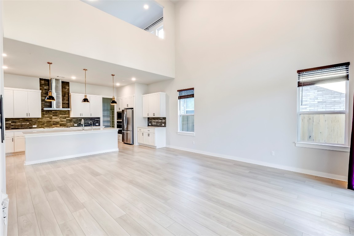 129 Cotton Tree Terrace Dripping Springs, TX 78620 - Photo 9 of 40 a view of kitchen with wooden floor