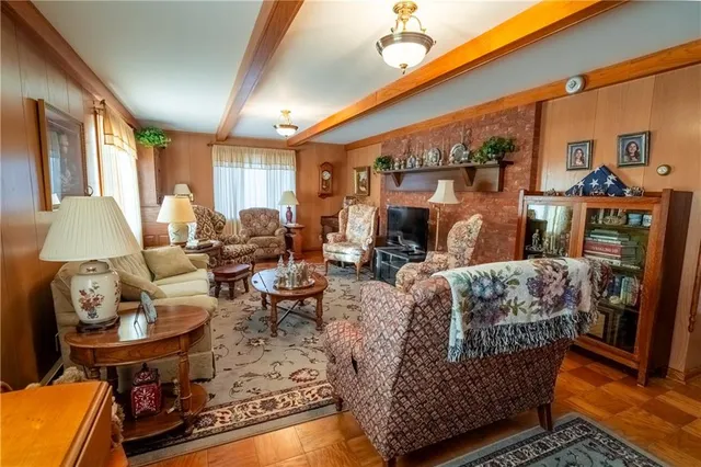 a living room with furniture a fireplace and a large window
