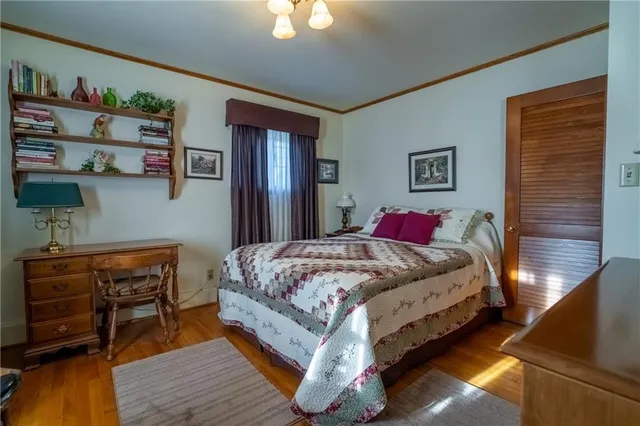 a bedroom with a bed dresser and a window
