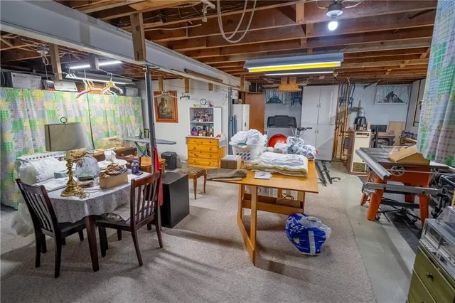 a front view of house with yard and trees in the background