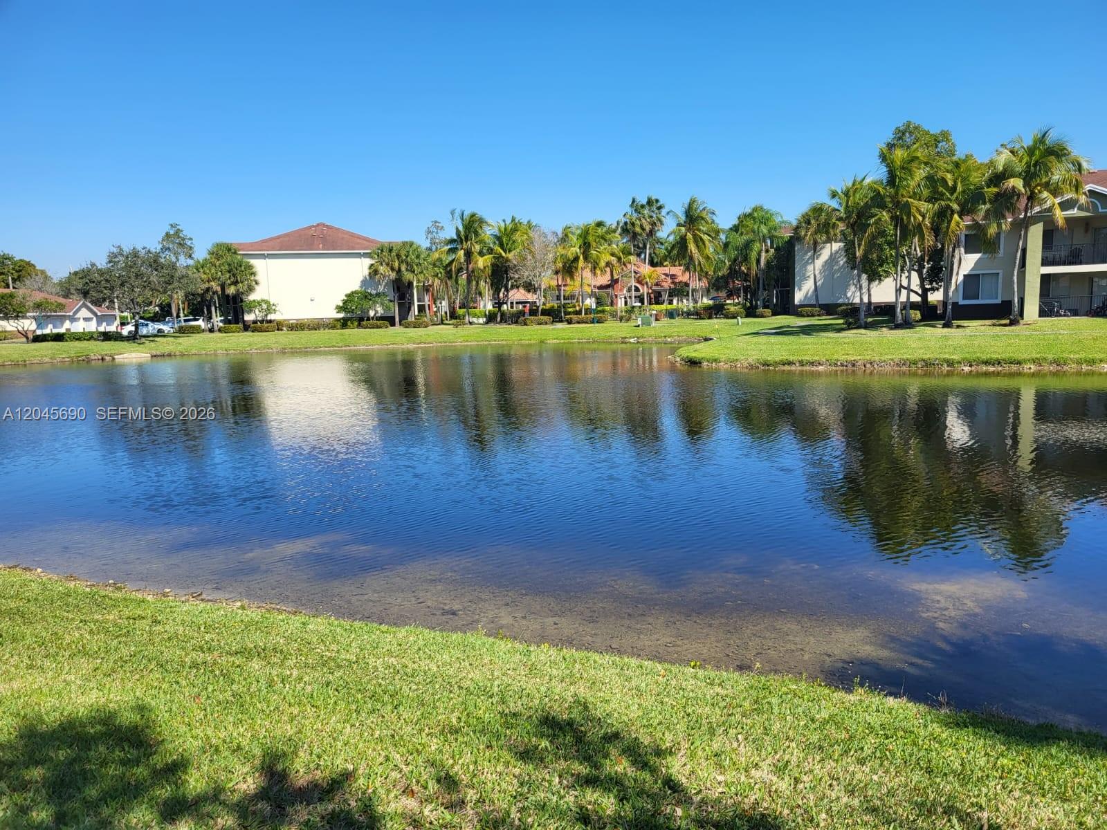 8070 North Nob Hill Road, Unit 208 Tamarac, FL 33321 - Photo 12 of 16 a view of a lake with houses in the background