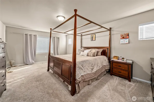 a bed room with a bed and a chair