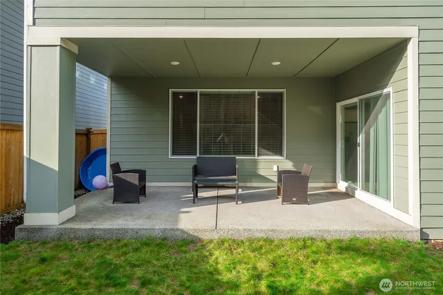 a backyard of a house with outdoor seating and a garden