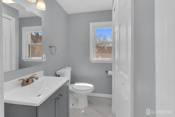 a white toilet sitting next to a bathroom sink