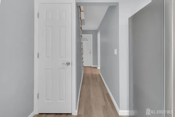 a view of a hallway with wooden floor