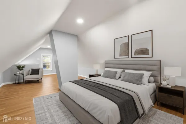 a bedroom with a large bed and a view of living room