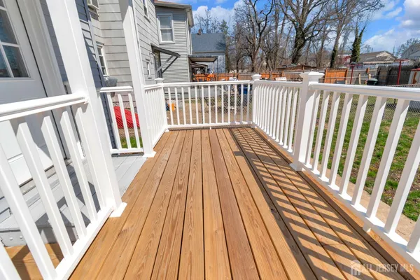 a view of outdoor space with deck and white furniture