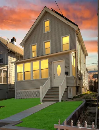 a front view of a house with a yard