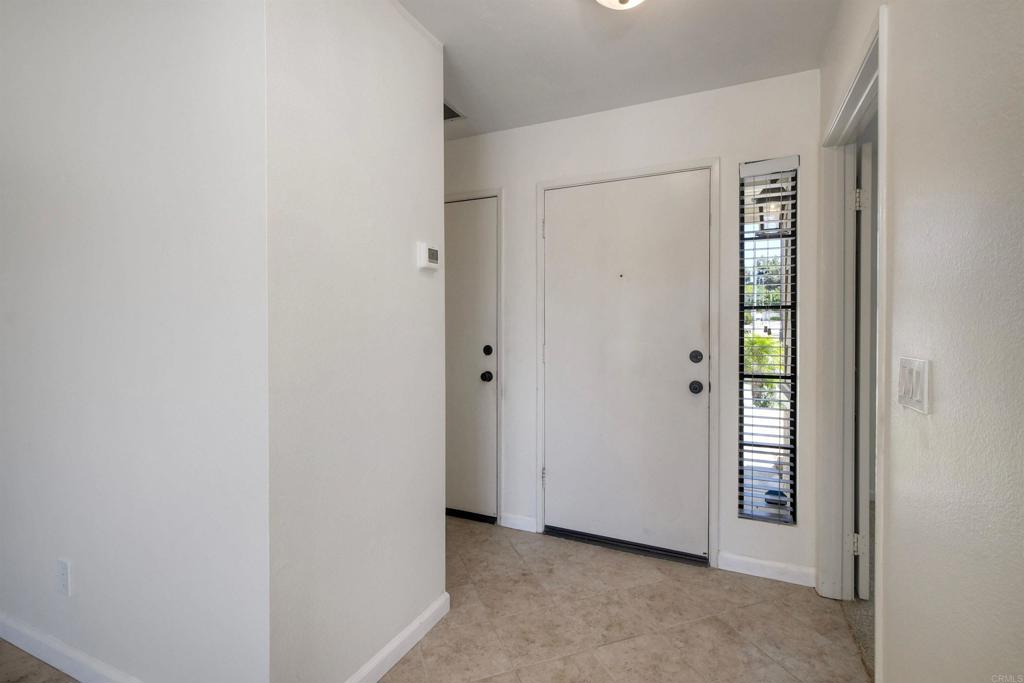 1394 Longfellow Road Vista, CA 92081 - Photo 7 of 50 a view of an empty room with closet and mirror