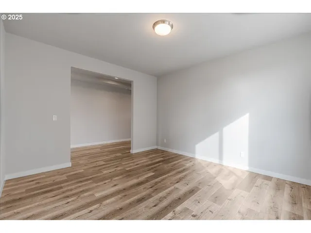 a view of hallway with wooden floor