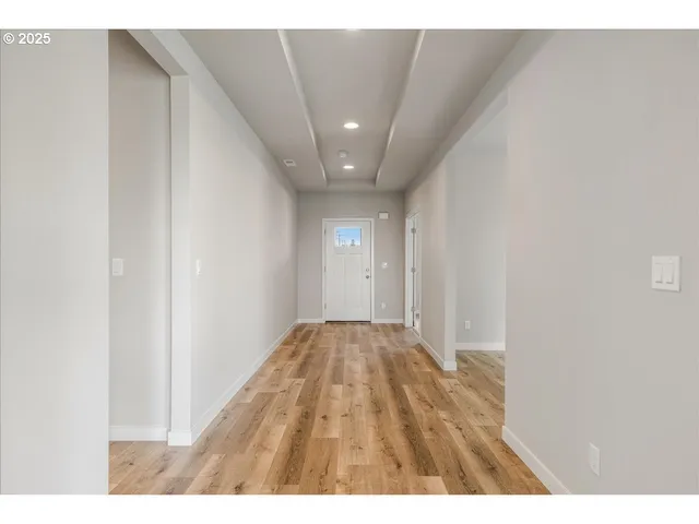 a view of kitchen and hall with wooden floor